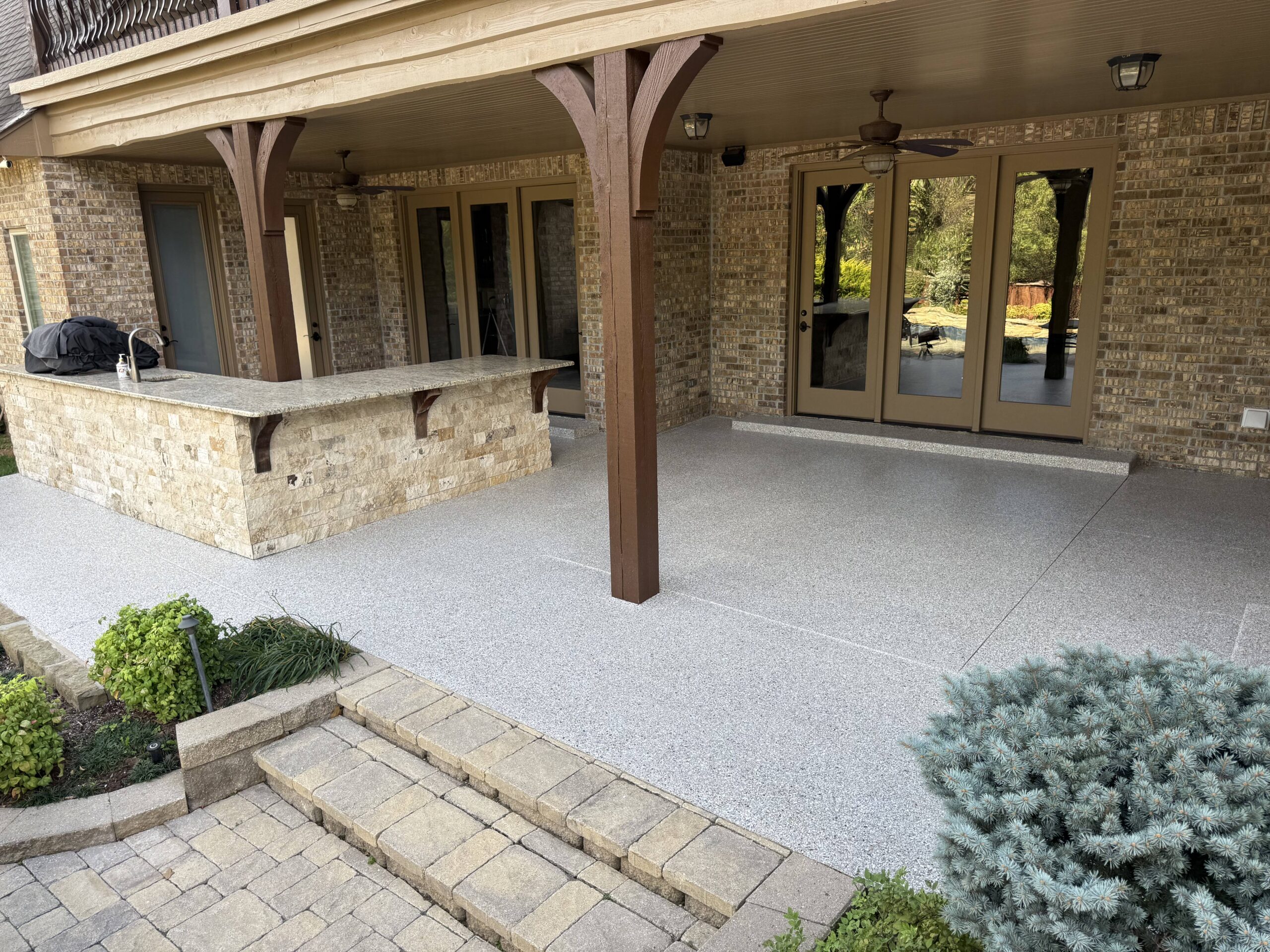 Polyaspartic flake floor installed on covered patio area