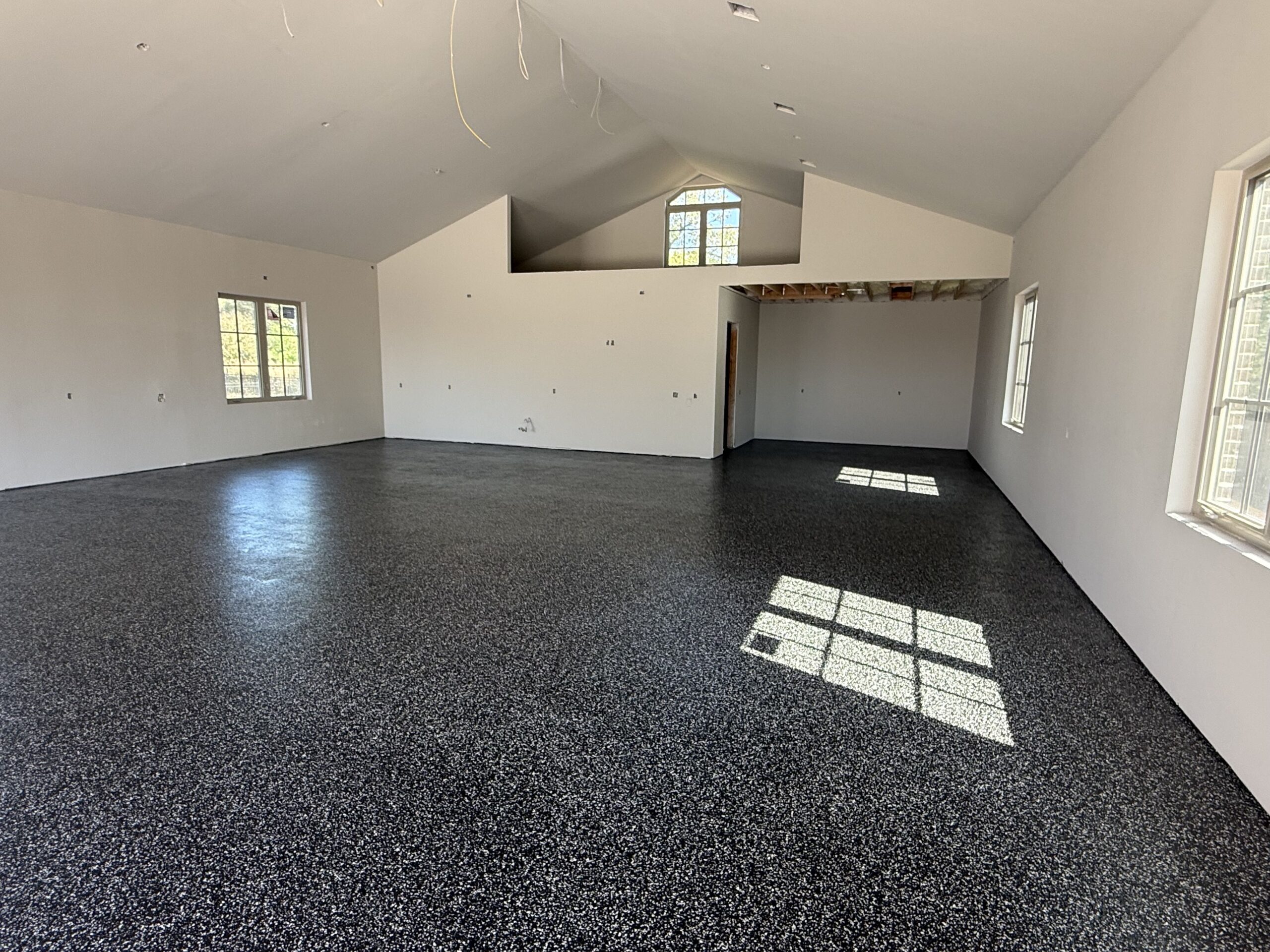 Large interior space with black flake epoxy floor coating