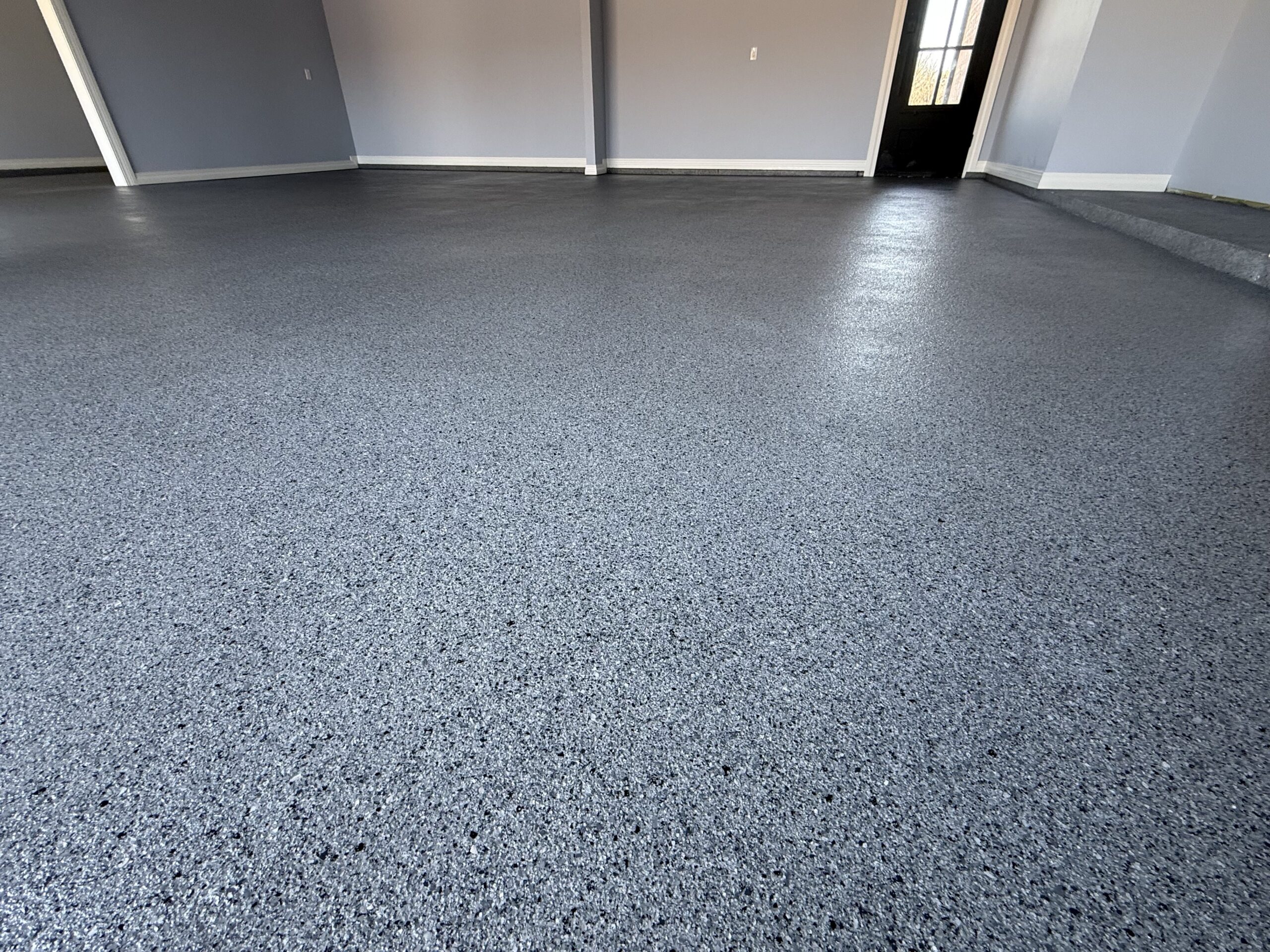 Finished flake epoxy garage floor with seamless, durable surface