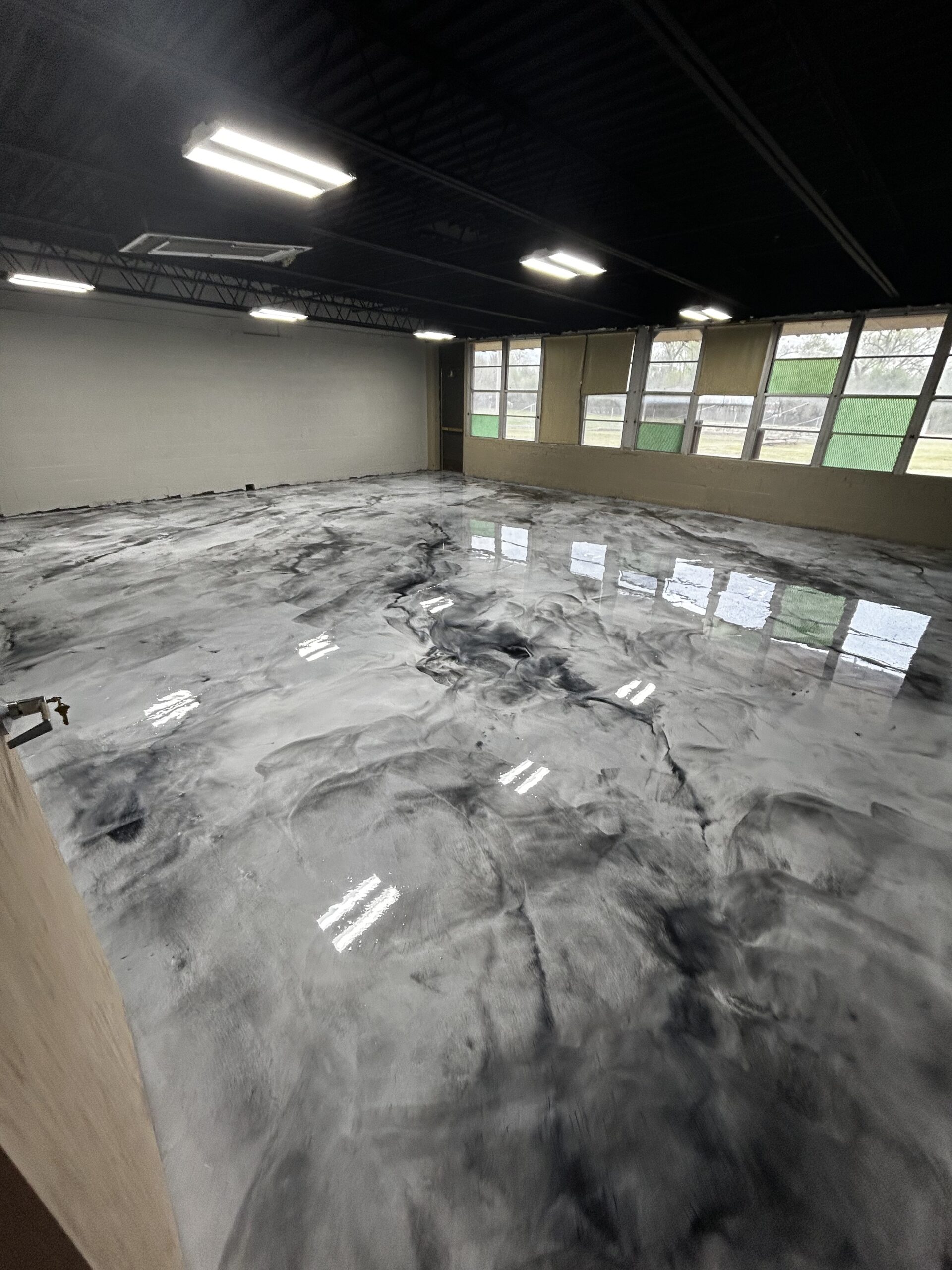 Metallic epoxy floor in storefront commercial space