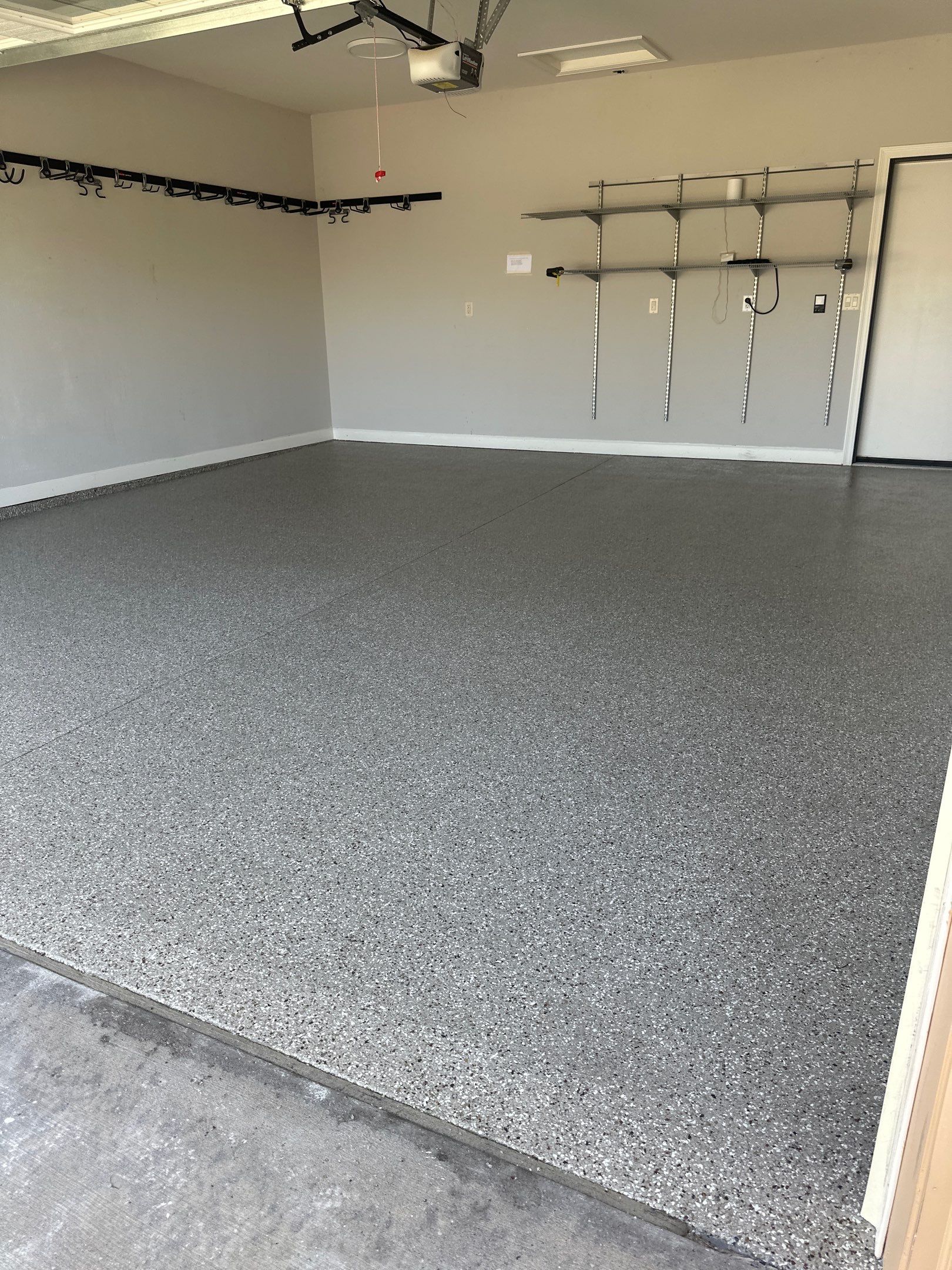 Epoxy garage floor coating with smooth grey finish installed by IronRock Concrete Coatings