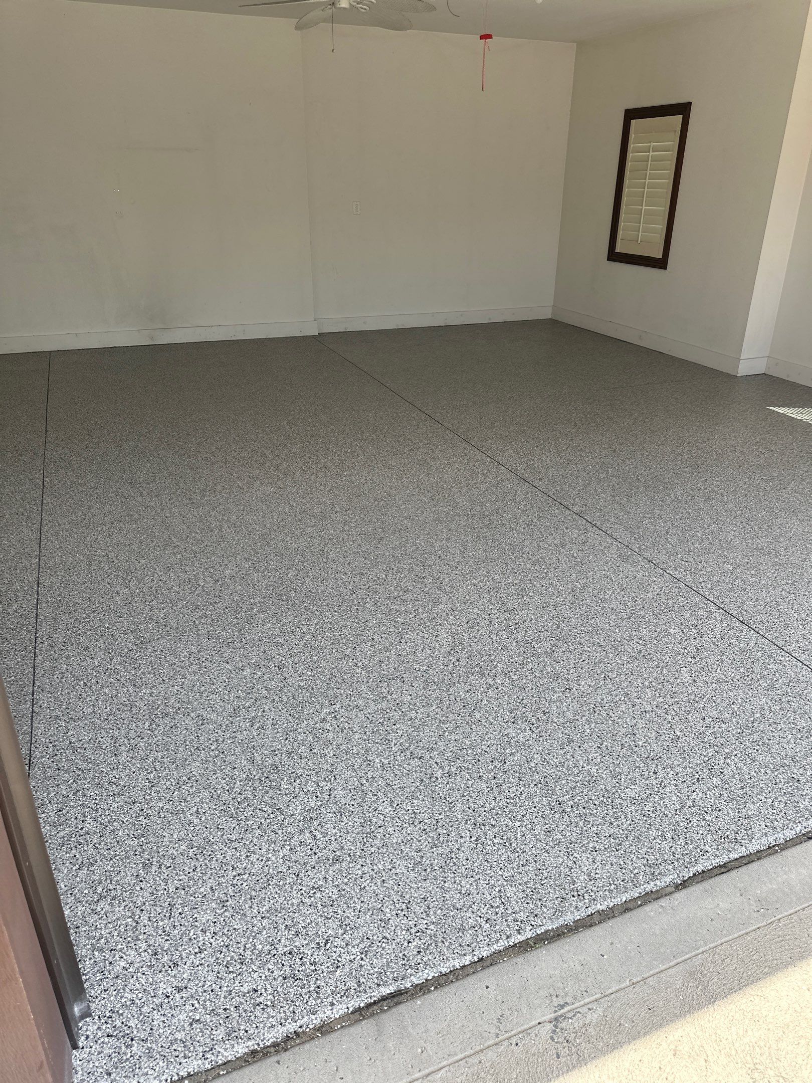 Polyaspartic flake garage floor with smooth, even finish