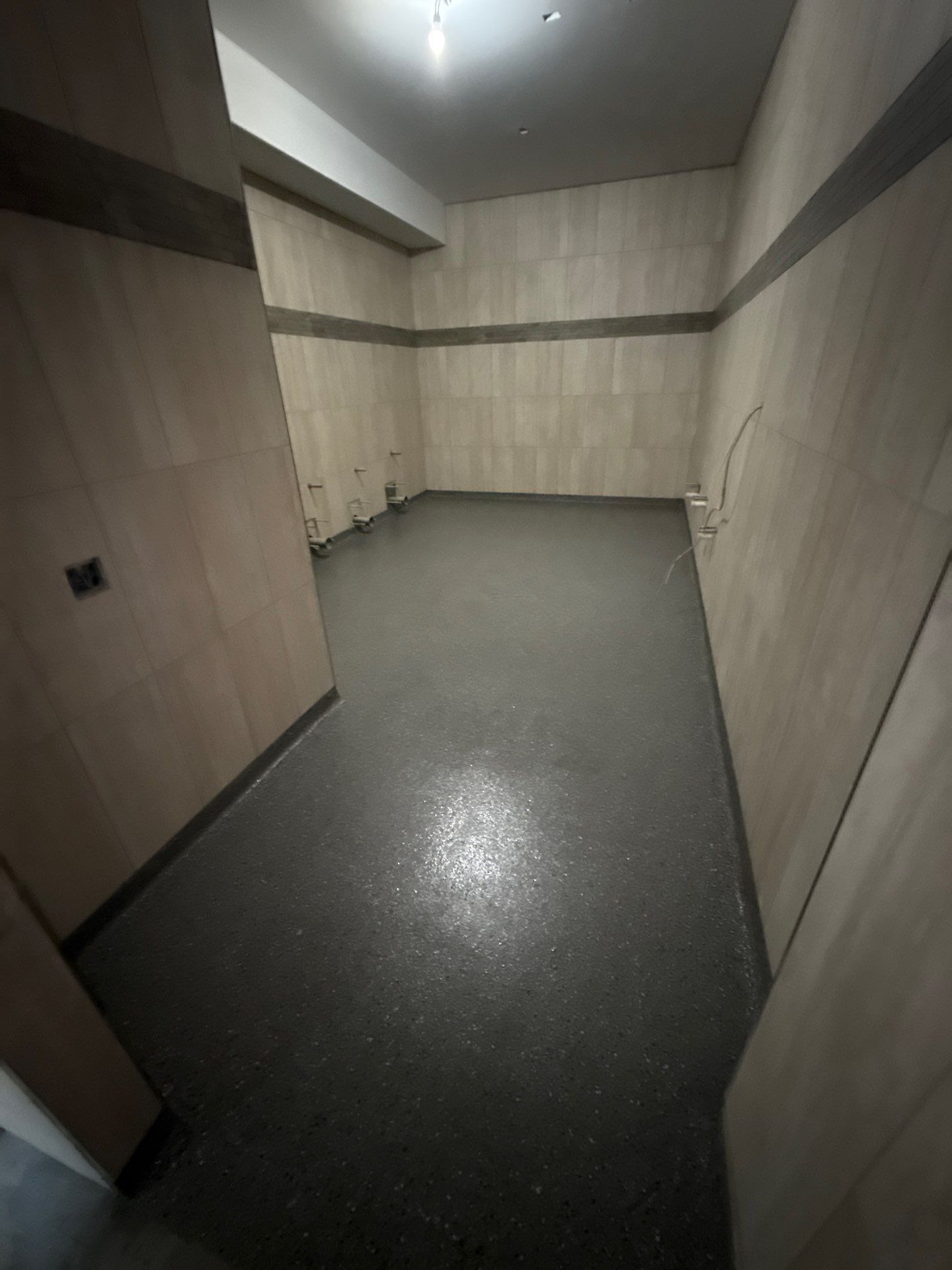 Solid grey epoxy floor installed in a commercial utility room
