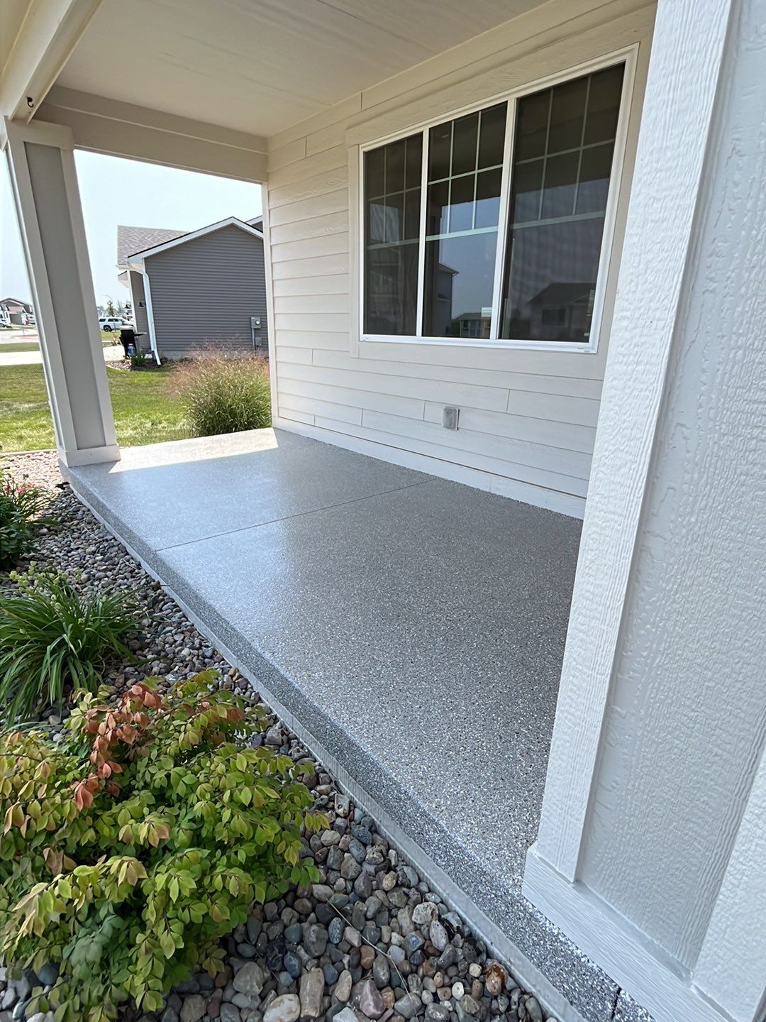 Polyaspartic concrete coating on a covered residential porch