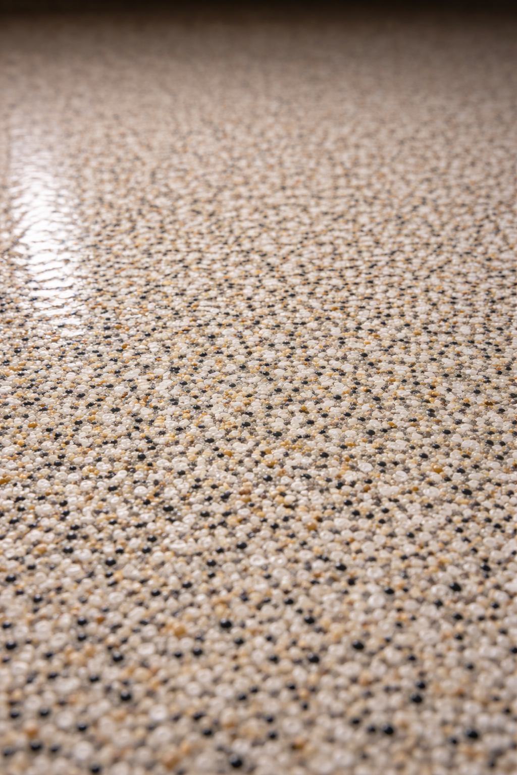 Close up of quartz epoxy floor coating showing textured anti slip surface on concrete.