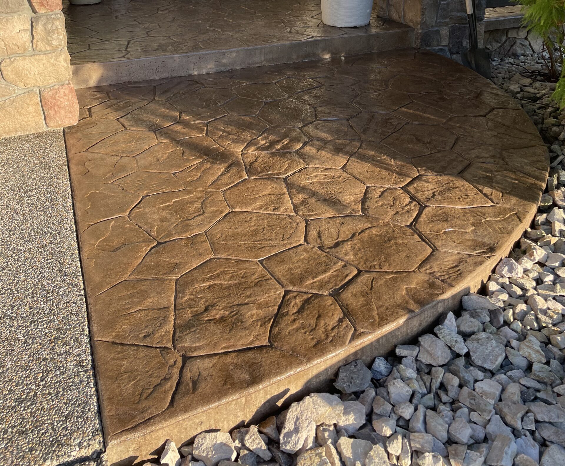Recoloured stamped concrete patio after concrete dyeing and sealing in Kelowna