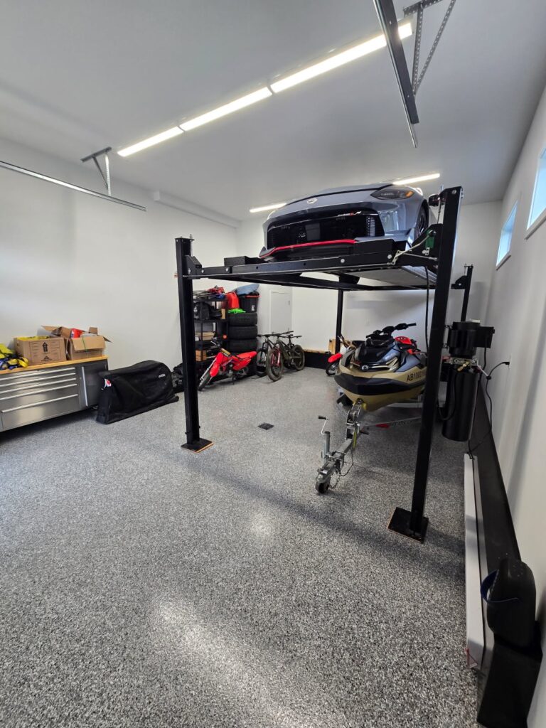 IronRock flake epoxy floor in a garage with a vehicle lift and workshop storage