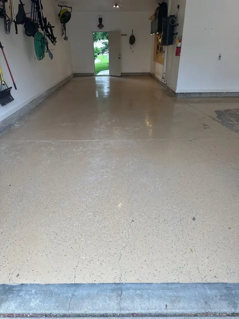 Before the project: IronRock flake coating on a garage floor