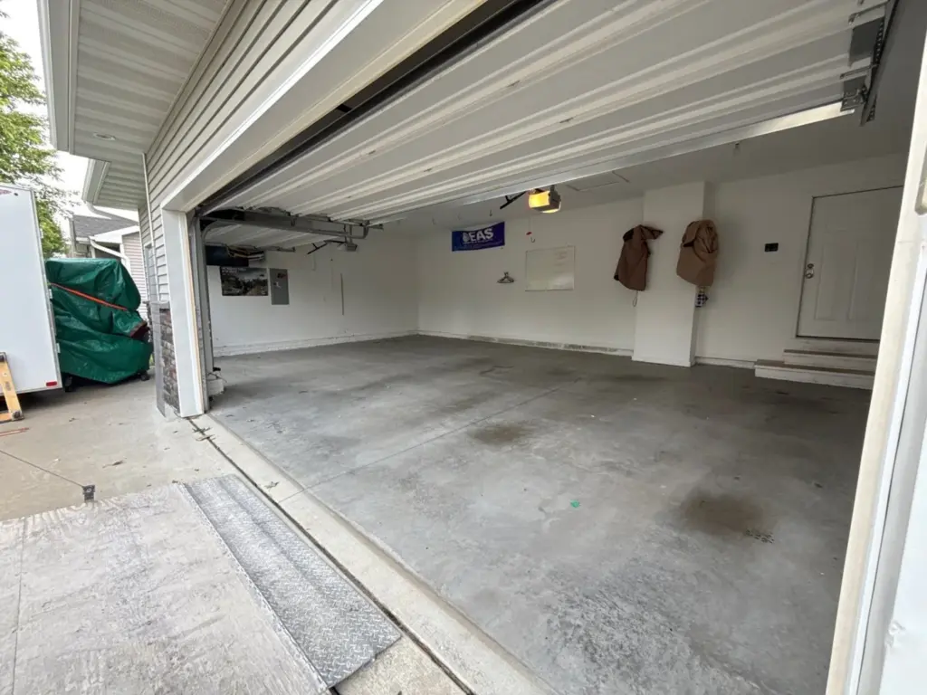 Before the project: IronRock flake coating on a garage floor