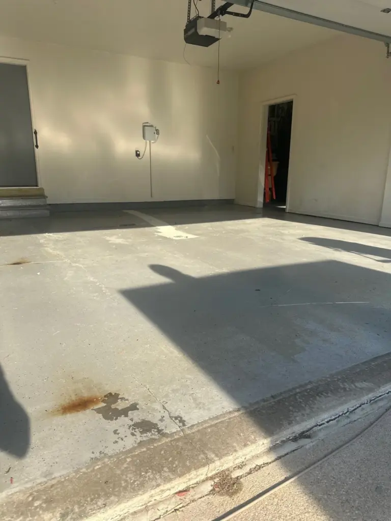 Before the project: IronRock flake coating on a garage floor