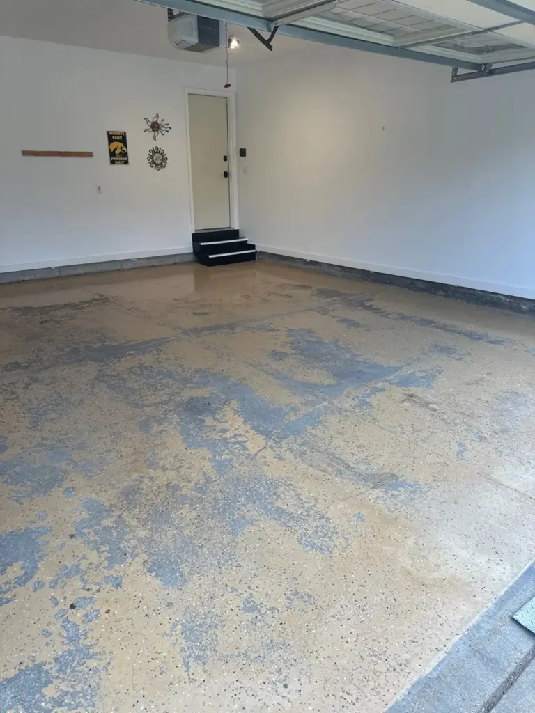 Before the project: IronRock flake coating on a garage floor